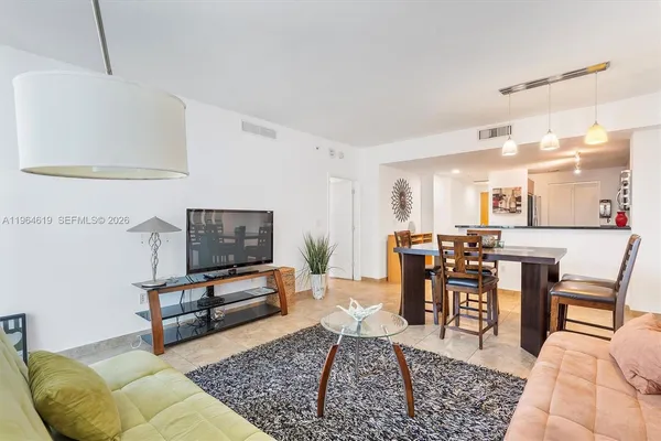 a living room with furniture and a rug