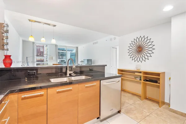 a kitchen with stainless steel appliances granite countertop a sink and cabinets