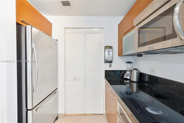 a kitchen with stainless steel appliances granite countertop a refrigerator and a sink