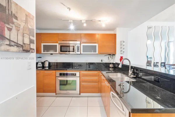a kitchen with stainless steel appliances granite countertop a sink and a stove