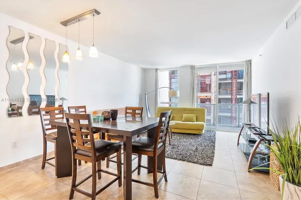 a dining room with furniture and wooden floor