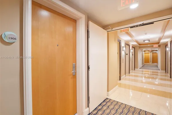 a living room filled with furniture and large windows