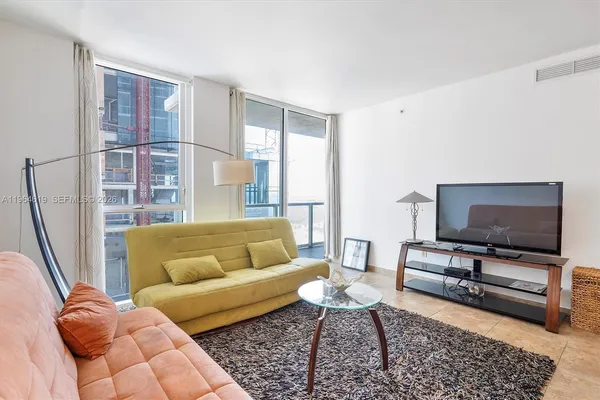 a living room with furniture and a flat screen tv