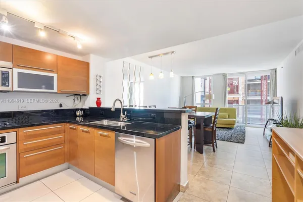 a kitchen with a sink and chairs