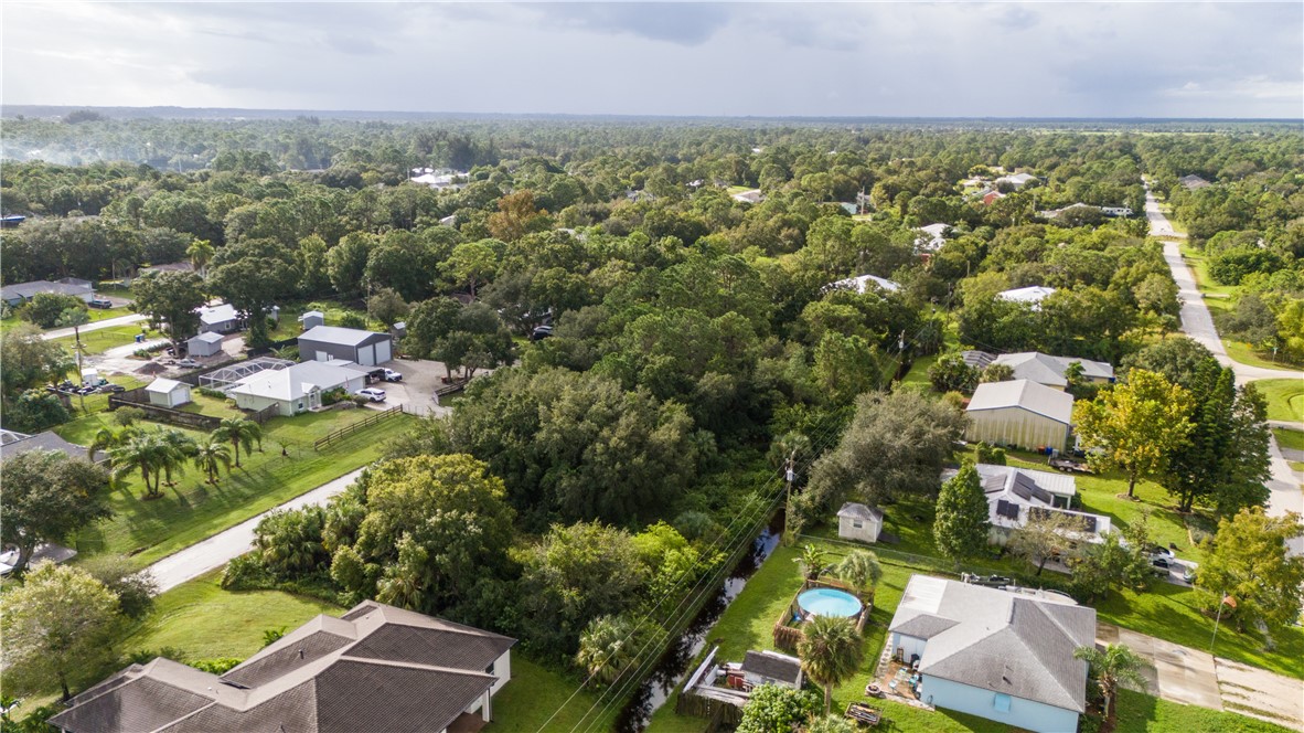 8435 96th Avenue Vero Beach, FL 32967 - Photo 11 of 20 an aerial view of residential houses with outdoor space and trees
