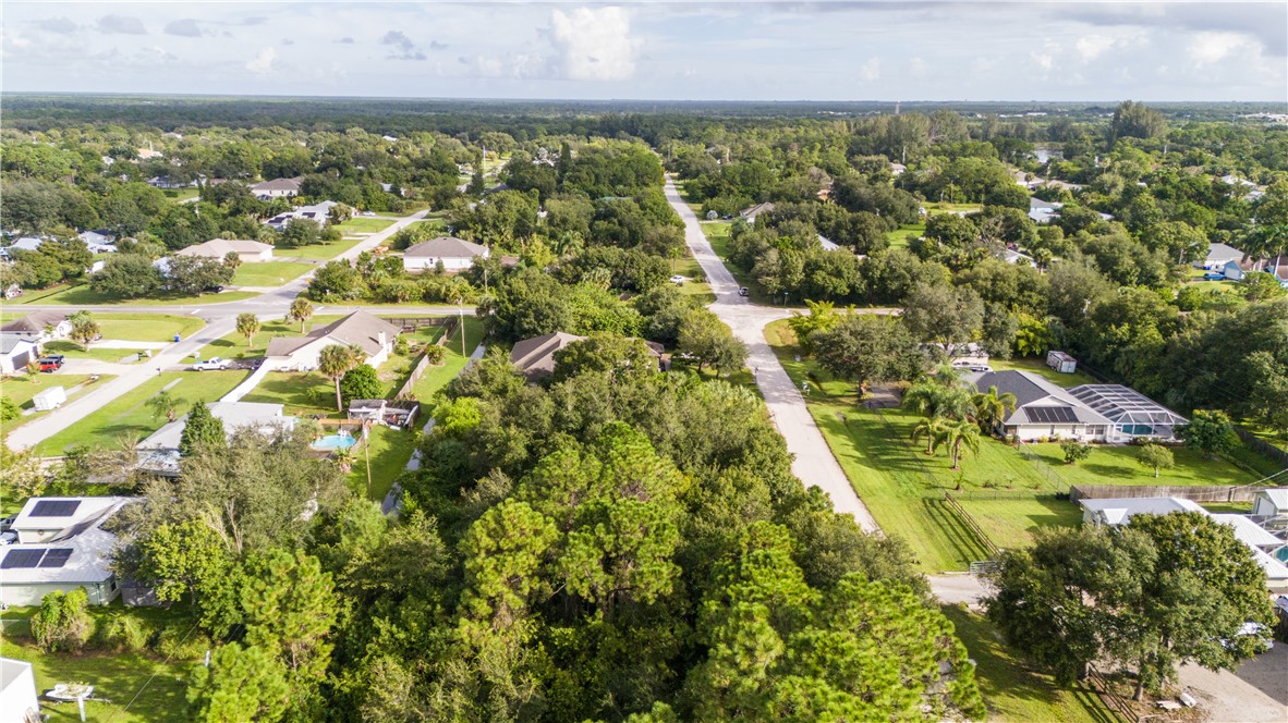 8435 96th Avenue Vero Beach, FL 32967 - Photo 7 of 20 an aerial view of residential houses with outdoor space and trees