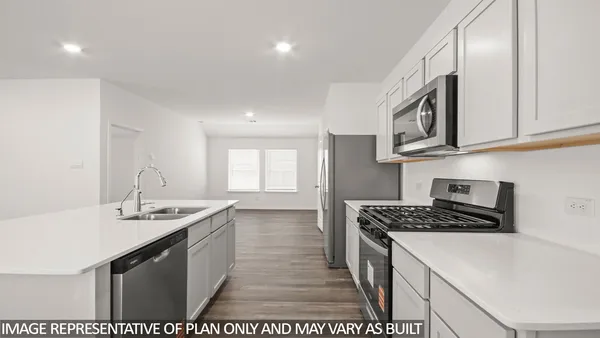 a kitchen that has a sink and a stove