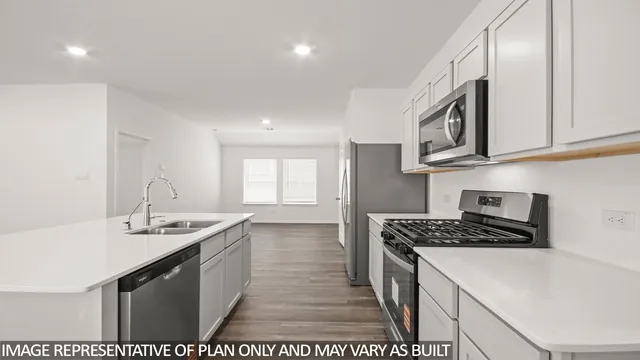 a kitchen that has a sink and a stove
