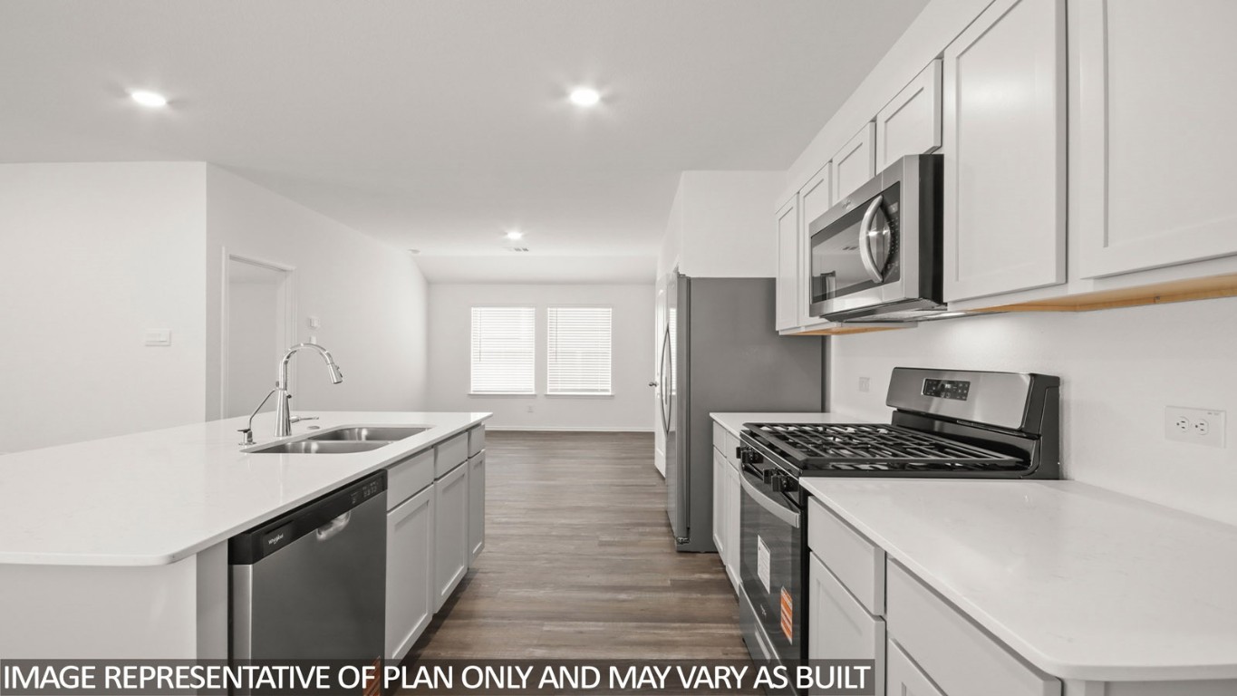 1706 Portia Lane Conroe, TX 77301 - Photo 2 of 21 a kitchen that has a sink and a stove
