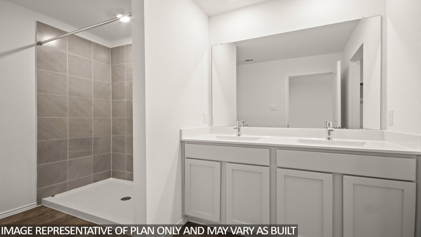 1706 Portia Lane Conroe, TX 77301 - Photo 7 of 21 a bathroom with a shower sink and mirror