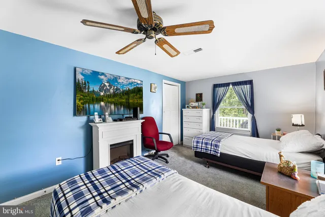 a bedroom with a bed a couch and a window