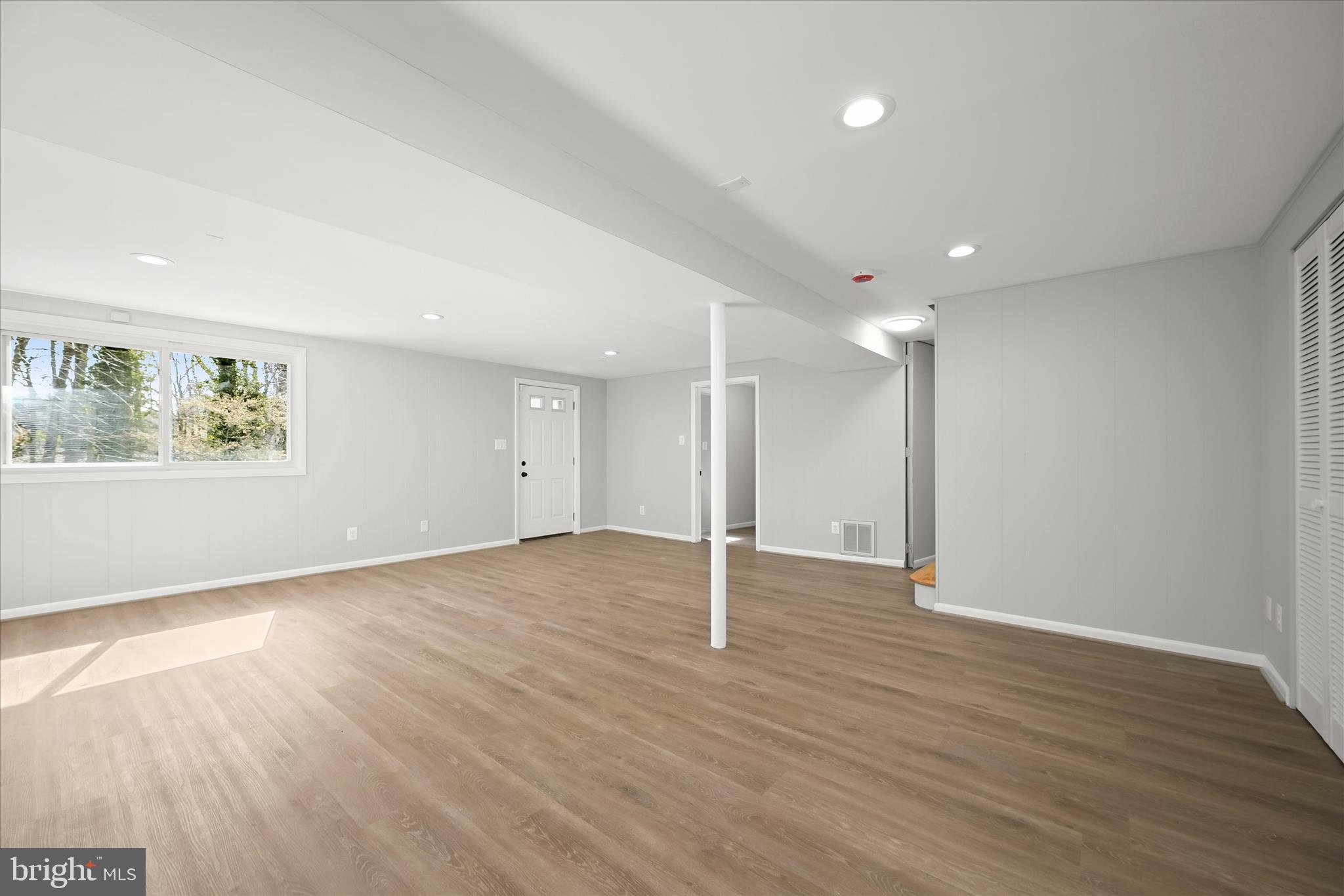 9720 Hedin Drive Silver Spring, MD 20903 - Photo 54 of 79 a view of an empty room with wooden floor and a window
