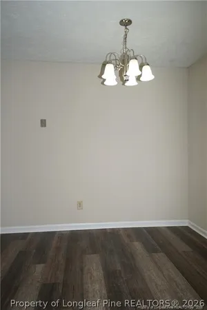 a view of a room with wooden floor and ceiling fan