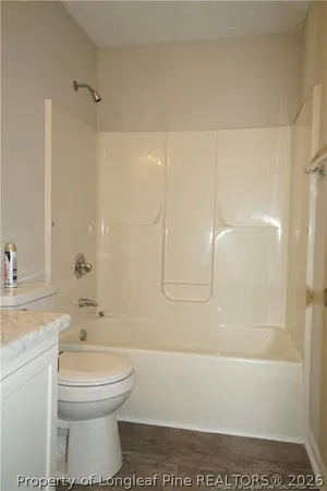 a bathroom with a toilet a sink and bathtub