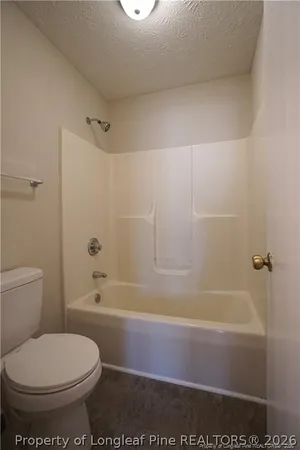 a bathroom with a toilet and a bathtub