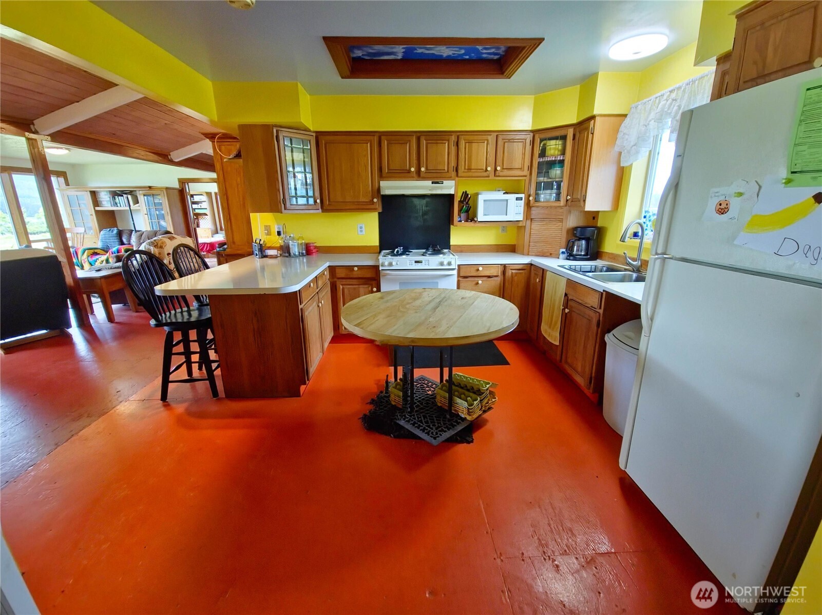 752 Parpala Road Naselle, WA 98638 - Photo 15 of 35 a living room with a table chairs and a refrigerator