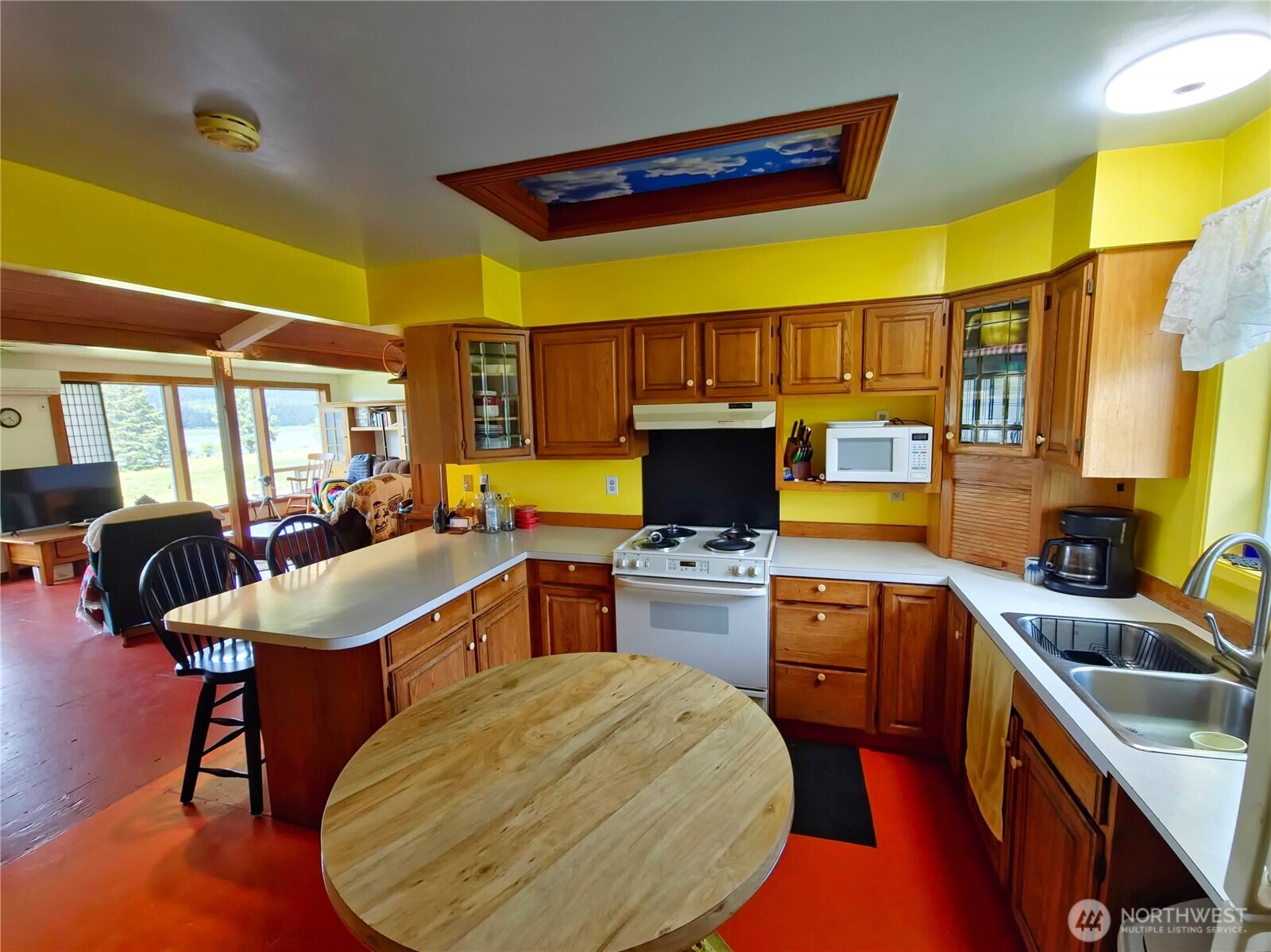 752 Parpala Road Naselle, WA 98638 - Photo 17 of 35 a kitchen with stainless steel appliances granite countertop a sink a stove a refrigerator cabinets and chairs
