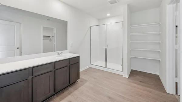 a bathroom with a double vanity sink and mirror