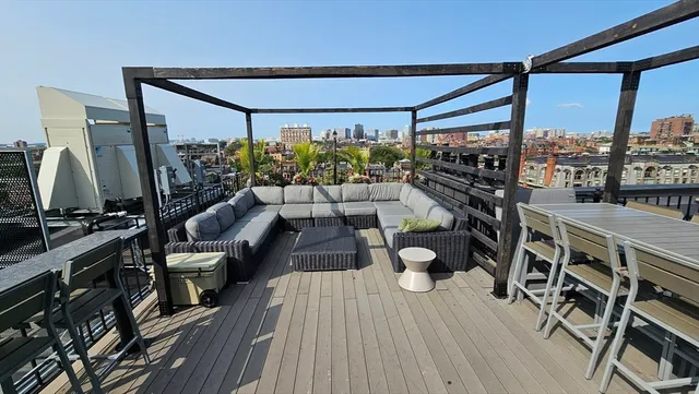 a living room with lots of furniture and a large window
