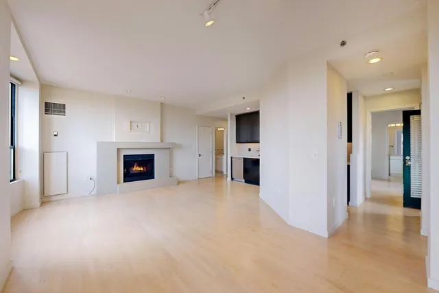 a view of empty room with a fireplace