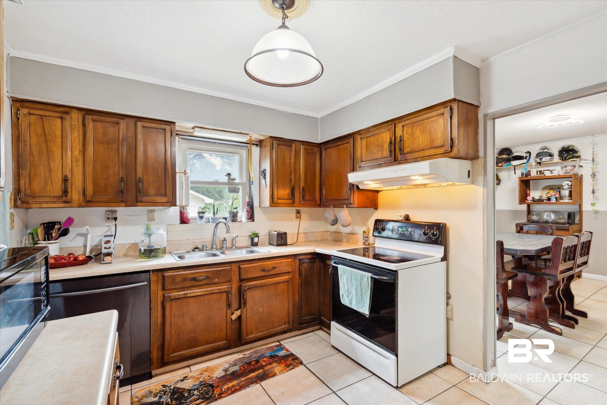 4851 Lesure Road Theodore, AL 36582 - Photo 5 of 21 Kitchen with ornamental molding, sink, white range with electric stovetop, and light tile patterned floors