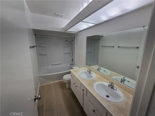 a bathroom with a tub sink and mirror