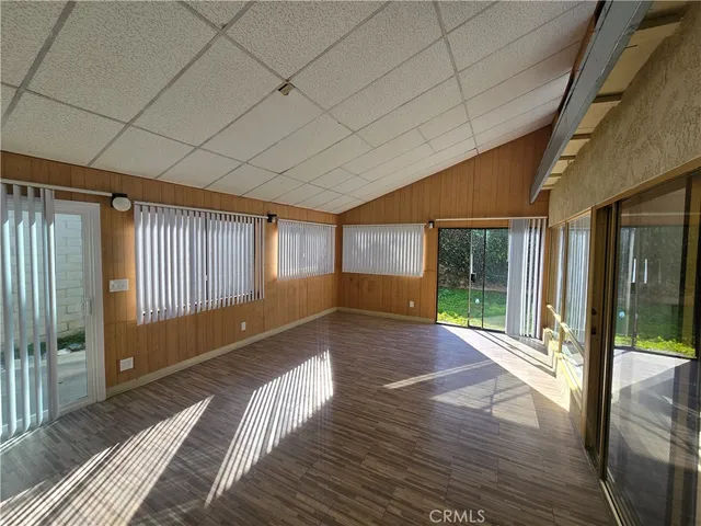 a view of a room with wooden floor and windows