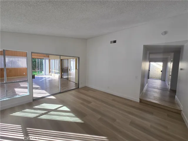 a view of a room with wooden floor