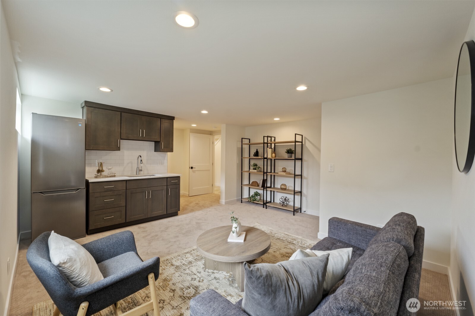 101 North 51st Street Seattle, WA 98103 - Photo 13 of 38 a large living room with stainless steel appliances furniture a rug and a view of kitchen