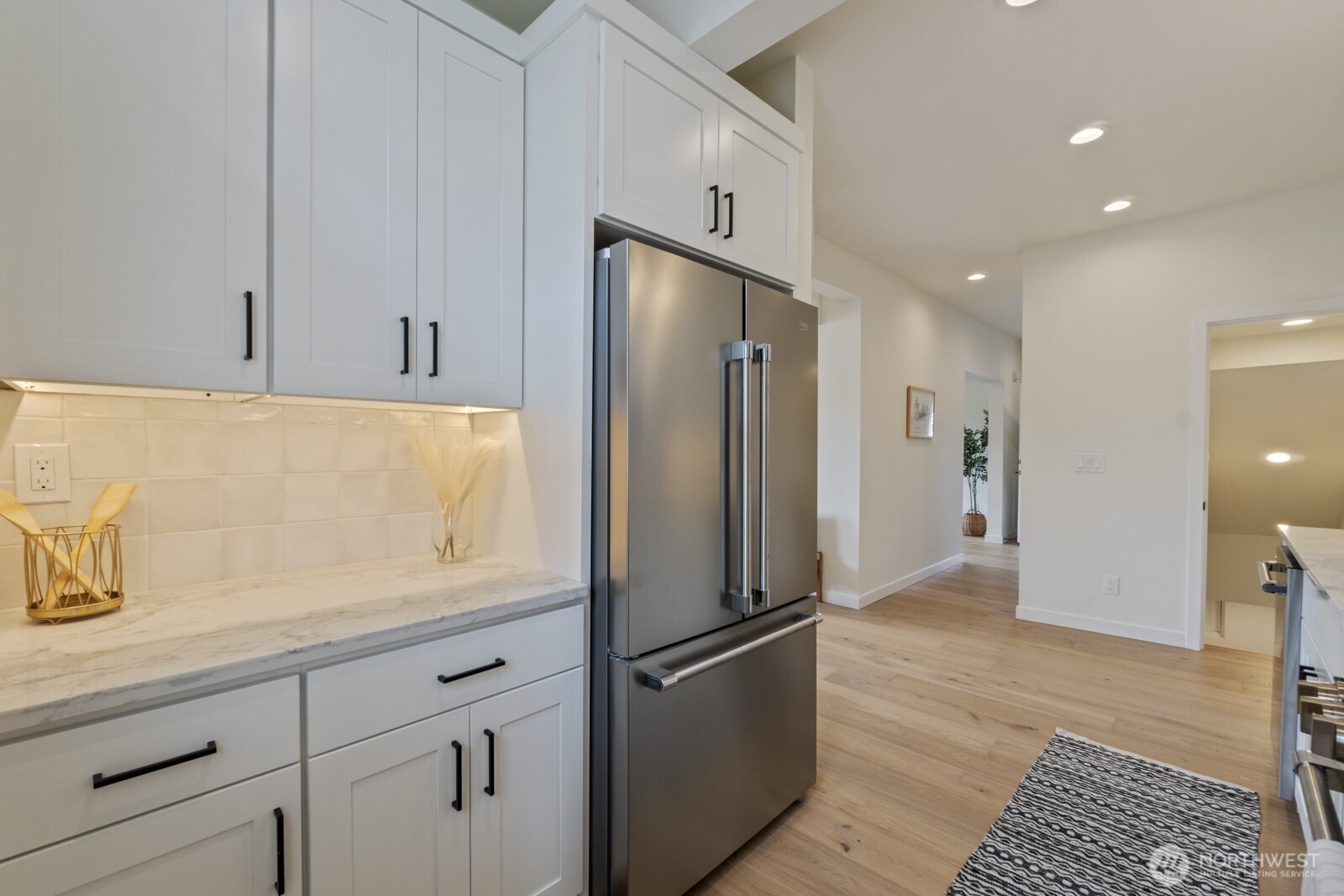 101 North 51st Street Seattle, WA 98103 - Photo 15 of 38 a kitchen with stainless steel appliances a refrigerator and a stove