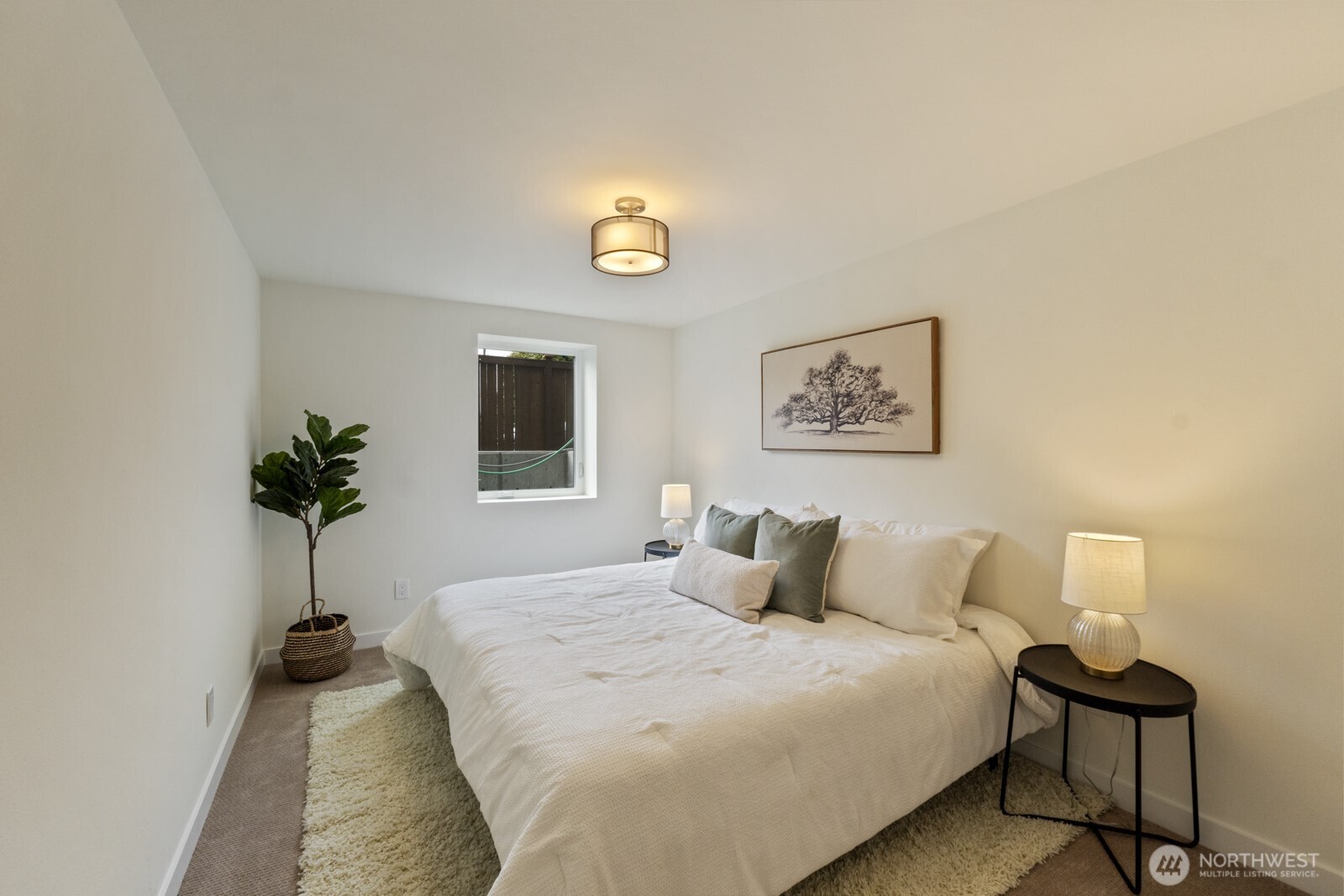 101 North 51st Street Seattle, WA 98103 - Photo 17 of 38 a bedroom with a bed and a potted plant