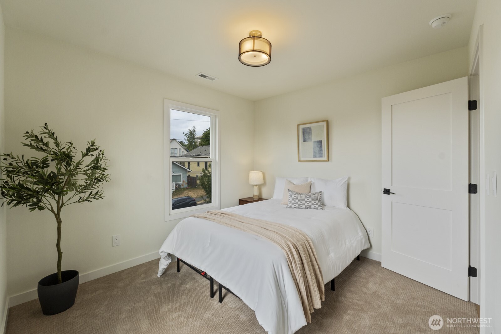 101 North 51st Street Seattle, WA 98103 - Photo 22 of 38 a bedroom with a bed and a potted plant