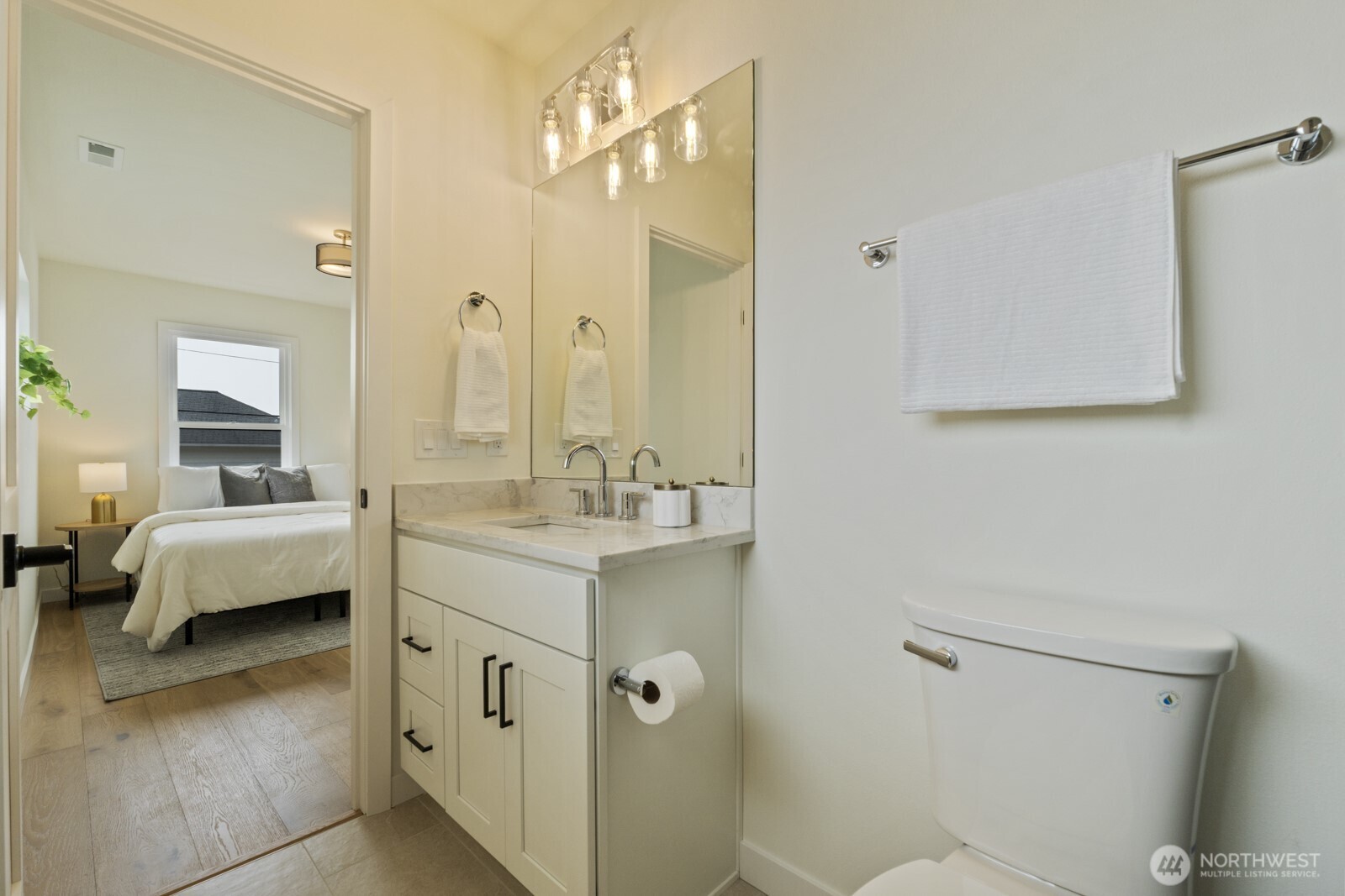 101 North 51st Street Seattle, WA 98103 - Photo 25 of 38 a en suite bathroom with a double vanity sink a mirror and a shower