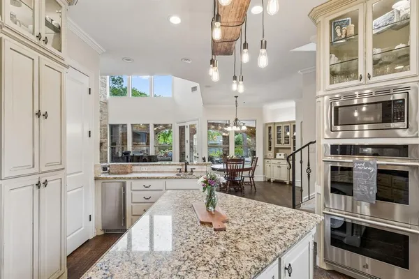 a kitchen with stainless steel appliances granite countertop a stove oven and a refrigerator
