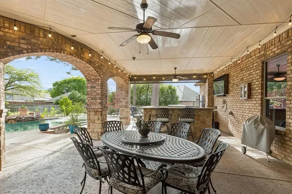 a view of a patio with a table and chairs