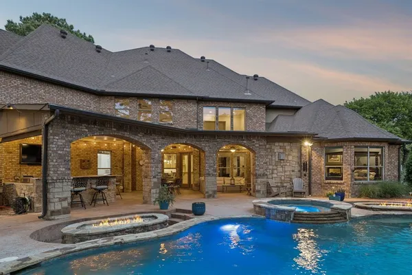 a view of a house with swimming pool and sitting area