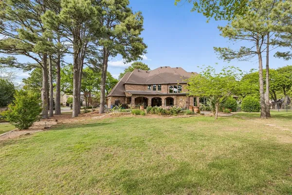 a front view of a house with yard and green space