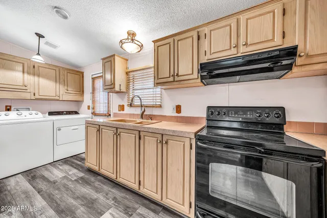 a kitchen with cabinets a refrigerator and a stove