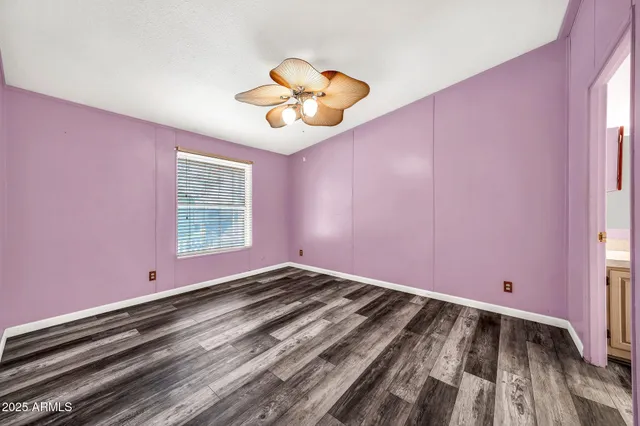 a view of a livingroom with a chandelier fan and a wooden floor