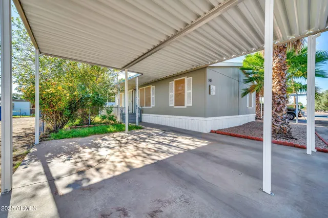 a view of a patio with table and chairs and floor to ceiling window