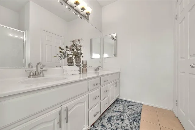 a bathroom with a double vanity sink and a mirror