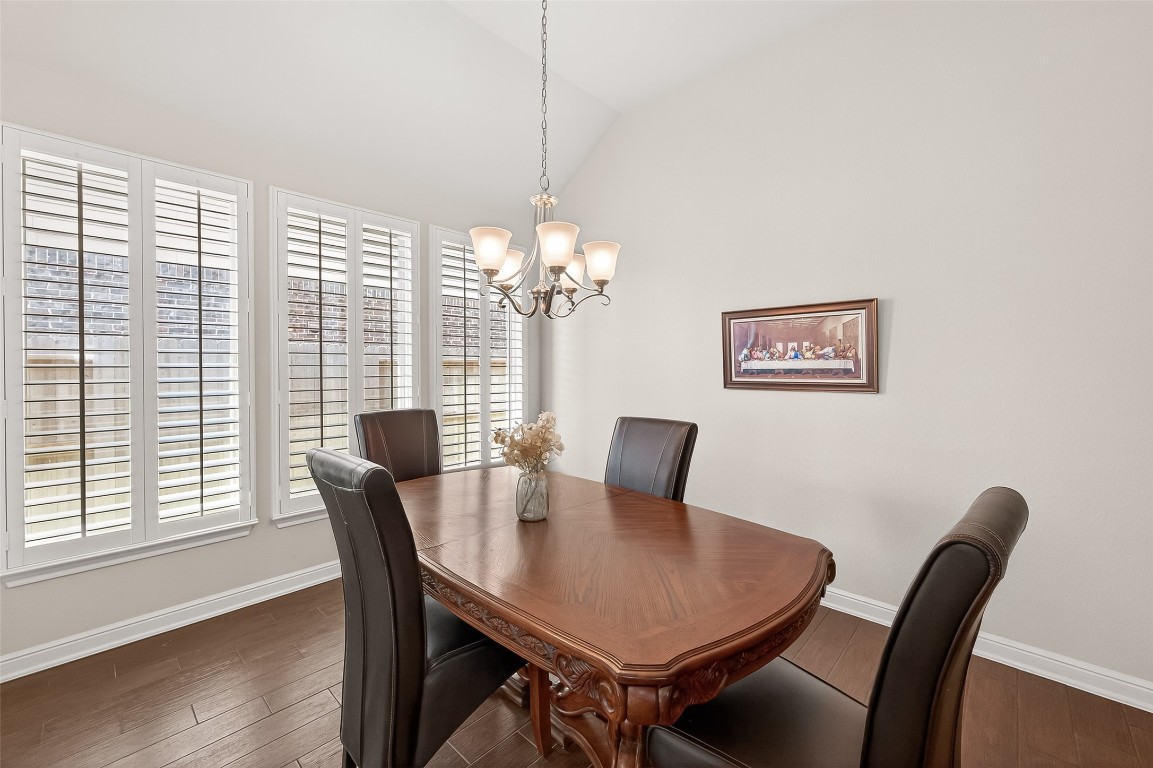 2719 Intrepid Trail Rosenberg, TX 77471 - Photo 17 of 50 a view of a dining room with furniture a chandelier and wooden floor