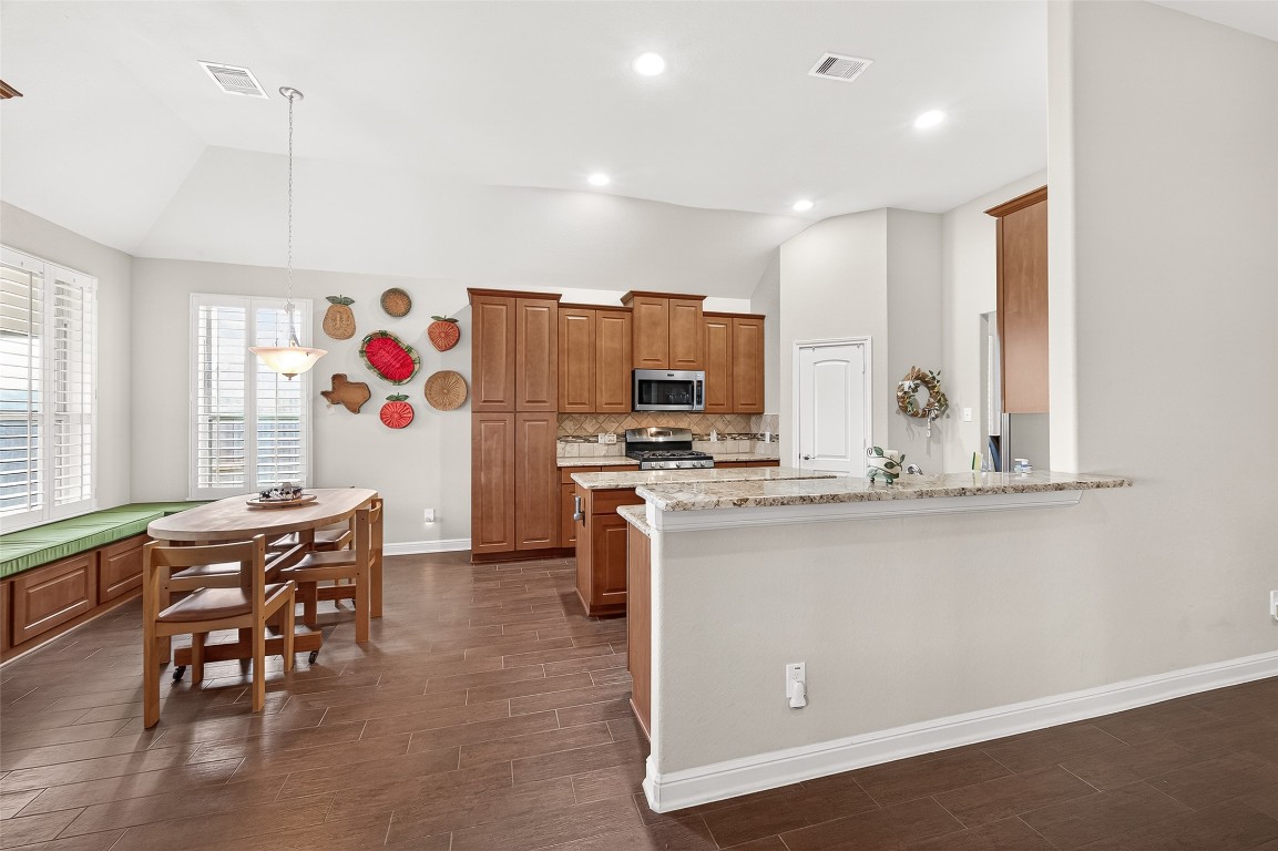 2719 Intrepid Trail Rosenberg, TX 77471 - Photo 27 of 50 a kitchen with stainless steel appliances granite countertop a sink and a refrigerator
