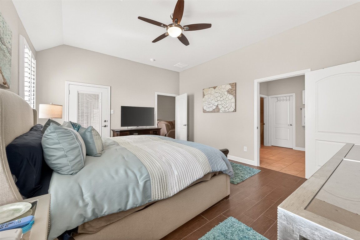 2719 Intrepid Trail Rosenberg, TX 77471 - Photo 36 of 50 a bedroom with a large bed and a chandelier