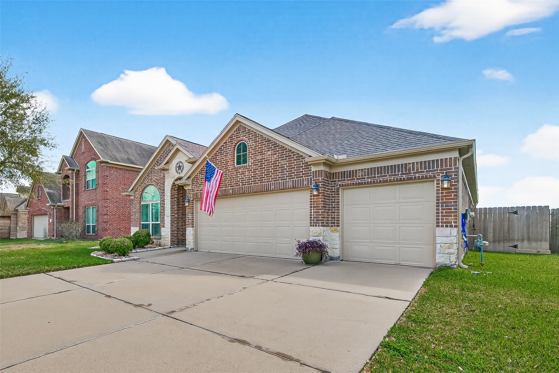 2719 Intrepid Trail Rosenberg, TX 77471 - Photo 7 of 50 a view of a white house with a small yard and a large tree