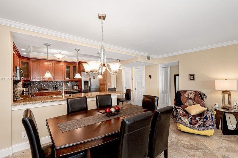 4751 Northwest 21st Street, Unit 504 Lauderhill, FL 33313 - Photo 9 of 27 a large kitchen with a table and chairs