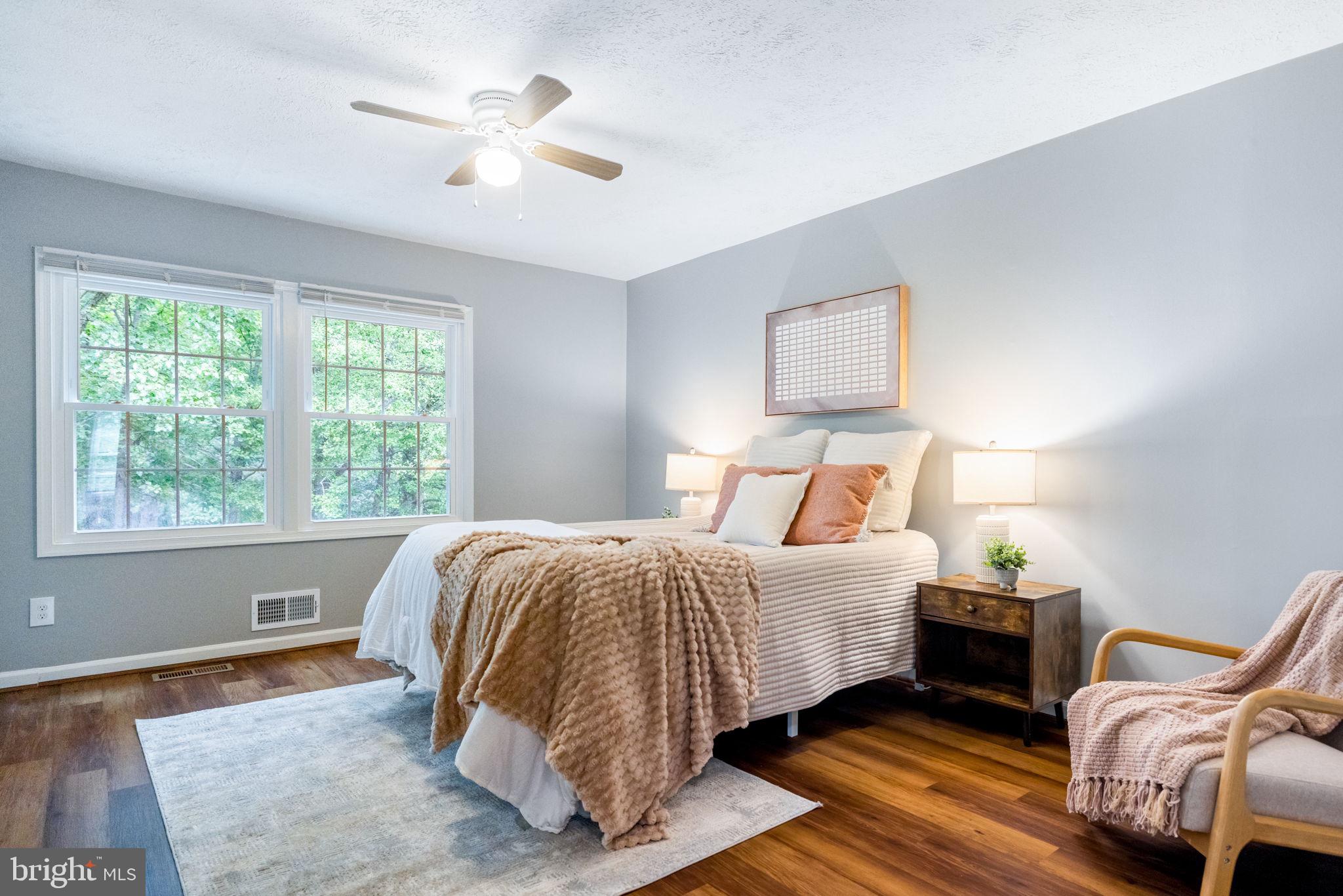 8204 Tory Road, Unit 136 Springfield, VA 22152 - Photo 19 of 36 a bedroom with a bed and wooden floor
