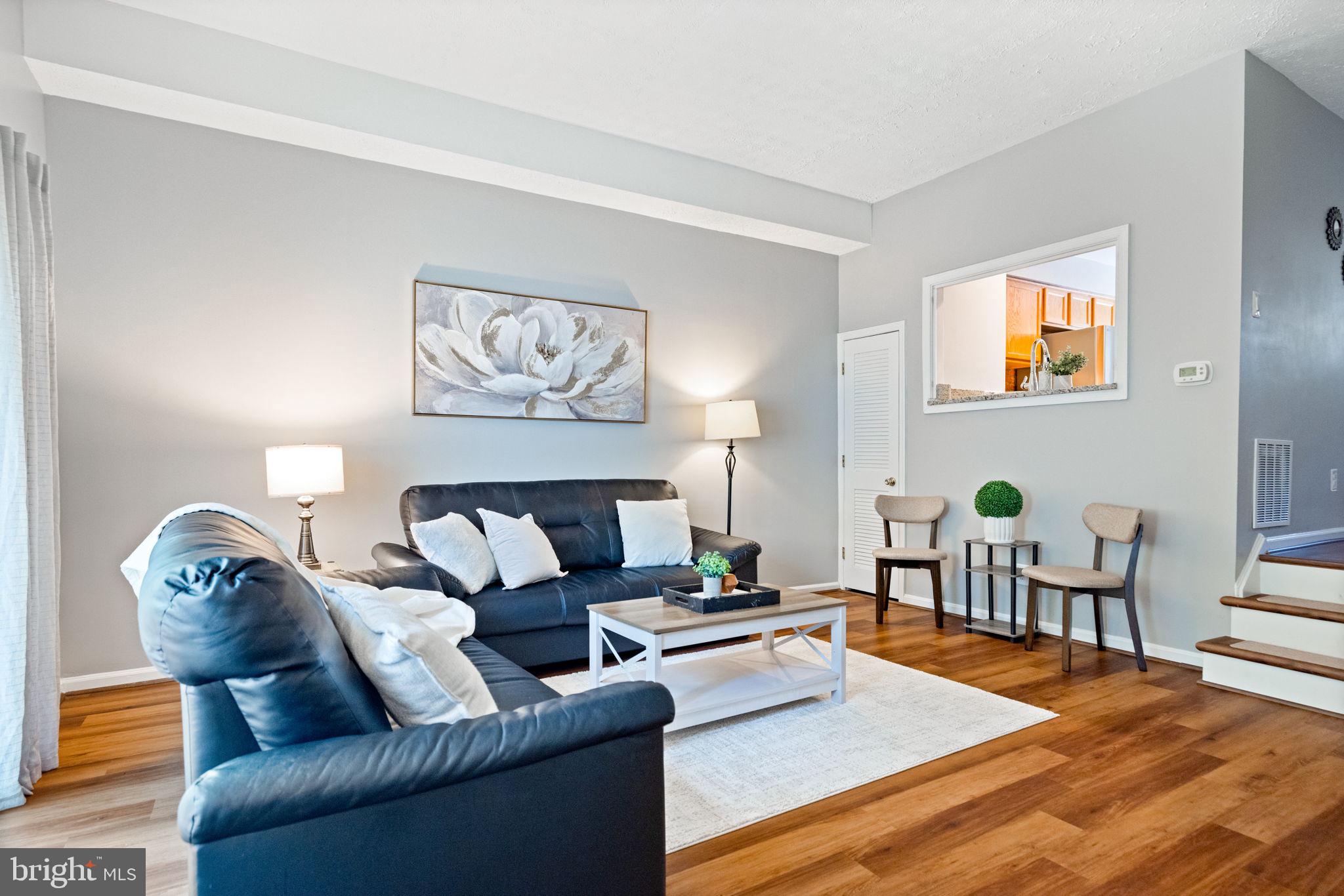 8204 Tory Road, Unit 136 Springfield, VA 22152 - Photo 3 of 36 a living room with furniture and wooden floor