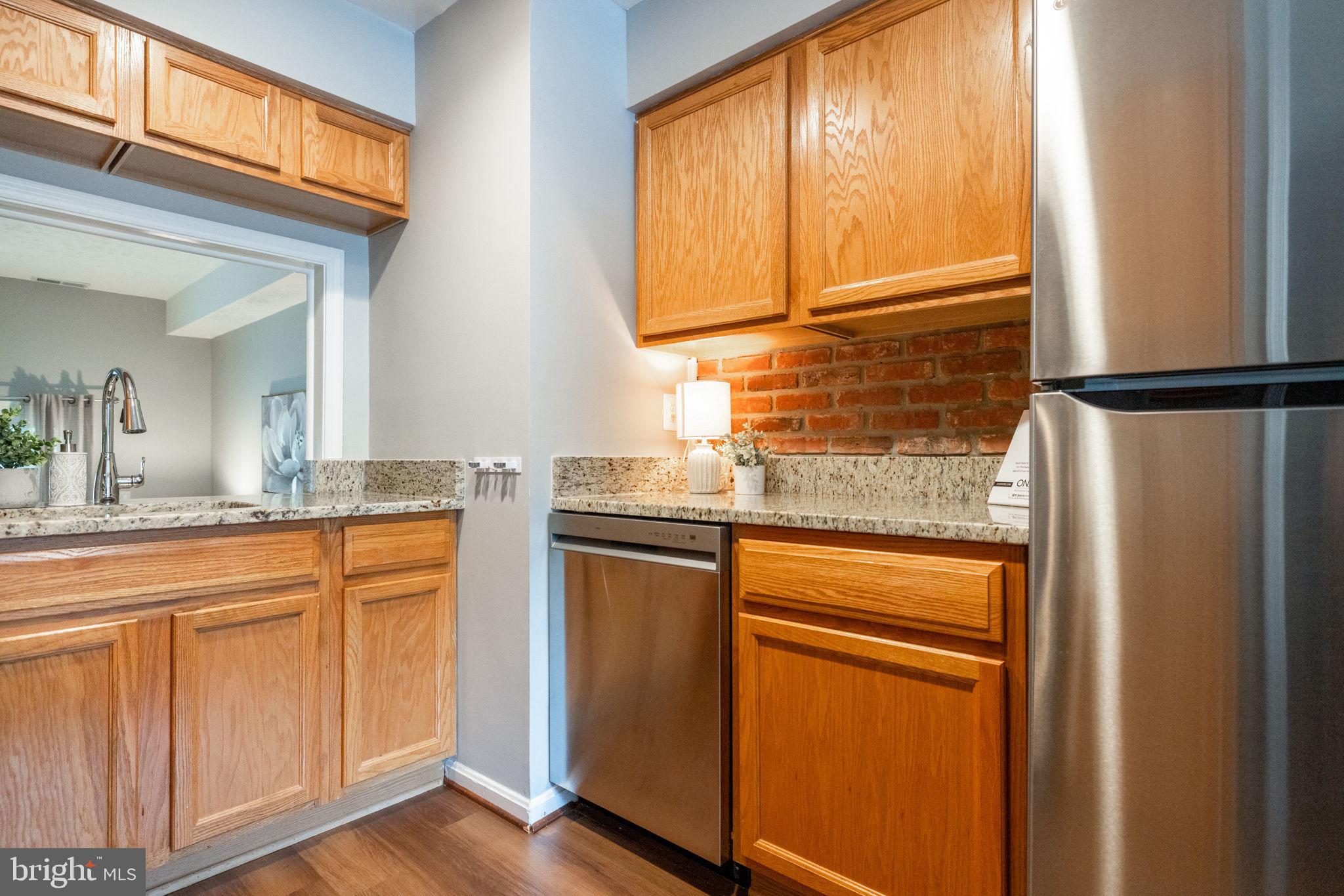 8204 Tory Road, Unit 136 Springfield, VA 22152 - Photo 9 of 36 a kitchen with stainless steel appliances granite countertop a refrigerator and cabinets