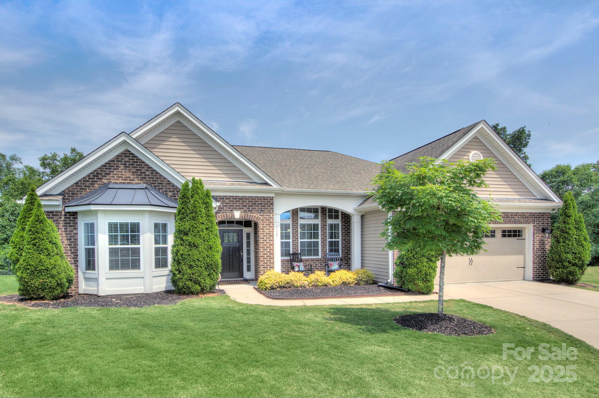 a view of a house with a yard and plants